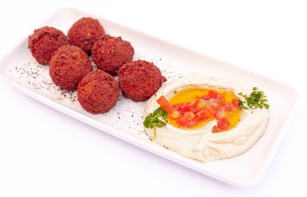 Hummus & Falafel · A mix of our creamy hummus dip. Served with spices of falafel and pocket bread.
