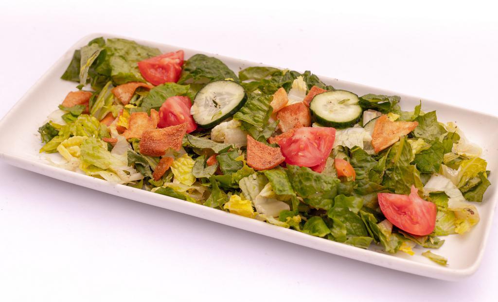 Fattoush Salad · A delightful mix of romaine lettuce, tomatoes, cucumbers, pita Crisps, spices with lemon juice and oil. Topped with your choice of meat.