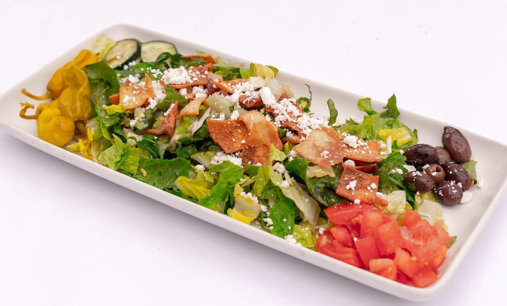 Greek Salad · A refreshing mix of romaine lettuce, tomatoes, cucumbers, pita crisps, spices, with lemon juice and oil. Topped with your choice of meat.