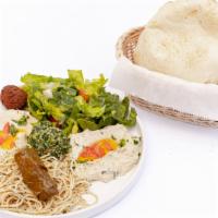 Vegetarian Plate · An assortment of stuffed grape leaves, falafel hummus, Baba ghanoush, pasta, tabbouleh fatto...