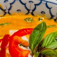 Panang Curry · Creamy red peanut  curry sauce, basil, bell pepper, and coconut milk.