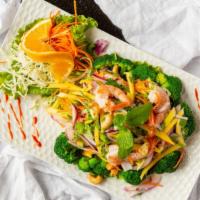 Thai Palace Paradise · Crispy Tilapia fish served with prawns, mango salad, cashew nut, red and green onion, with l...