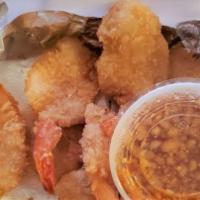 Coconut Crusted Shrimp · Golden fried crispy coconut shrimp served with sweet and sour sauce.