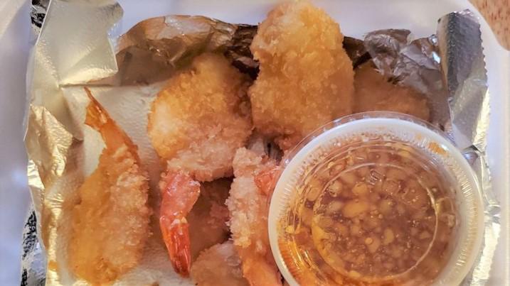 Coconut Crusted Shrimp · Golden fried crispy coconut shrimp served with sweet and sour sauce.