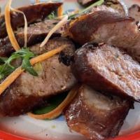 Lao Sausages (Sai Oua Moo) · Northern Lao style sausages, ground pork, lemongrass, herbs, served with purple or white sti...