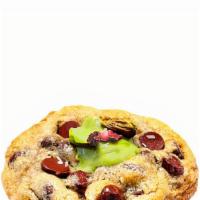 Daddy Cool · Tahini chocolate chunk cookie with sea salt, pistachio butter and rose petal topping.