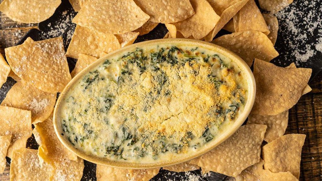 Spin Dip · spinach, artichokes, garlic parmesan cream sauce & crispy tortilla chips