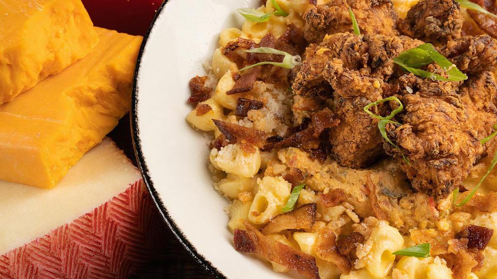 True South · mac’s cheese sauce, creamy cheddar, parmesan & pimento cheese, southern fried chicken, candied bacon, capped with spiced crispies & scallions