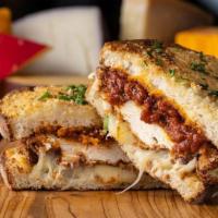 The God'Feather · toasted parmesan crusted sourdough, creamy herb cheese, triple stacked with cheddar, mozzare...