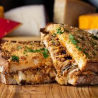 Tex-Mex · toasted parmesan crusted sourdough, creamy herb cheese, triple stacked with cheddar, mozzare...