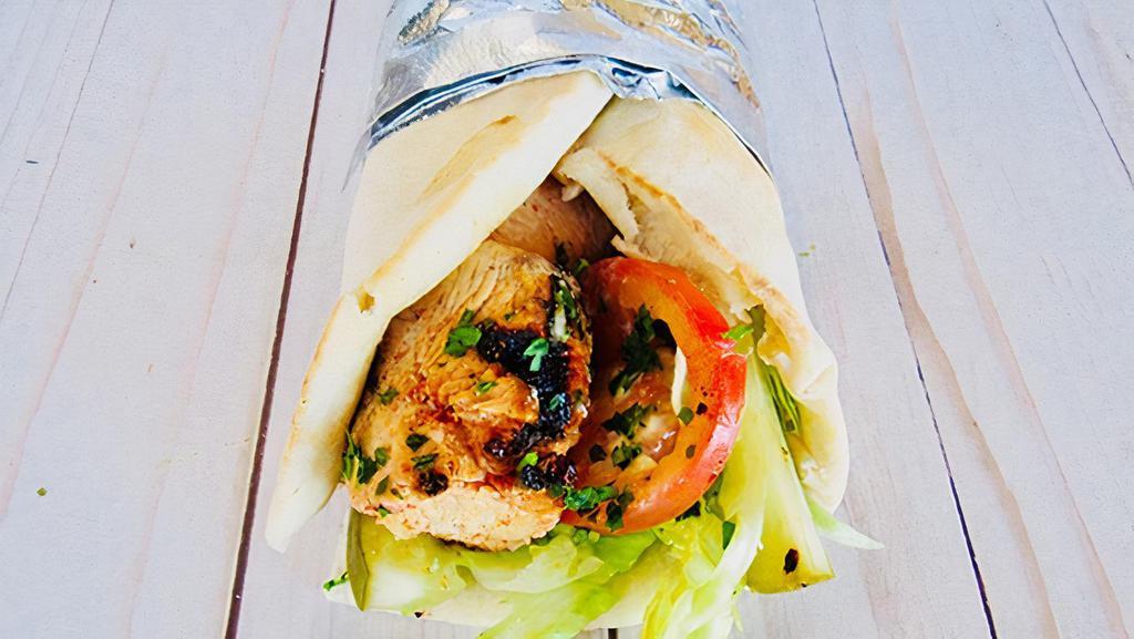 Chicken Shawarma Sandwich · Chicken marinated with special seasonings, slowly roasted, thinly sliced and wrapped in fresh pita bread with garlic sauce, lettuce, tomatoes and pickles.