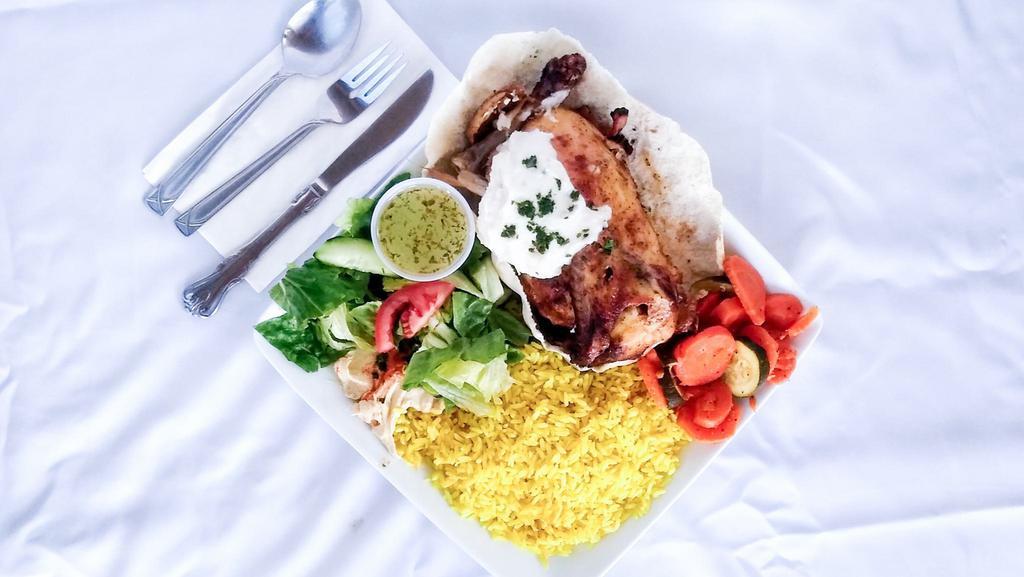 Roasted Half Chicken Dinner · Middle Eastern seasoned rotisserie chicken, topped with garlic sauce. Served with rice, hummus, salad and vegetables.