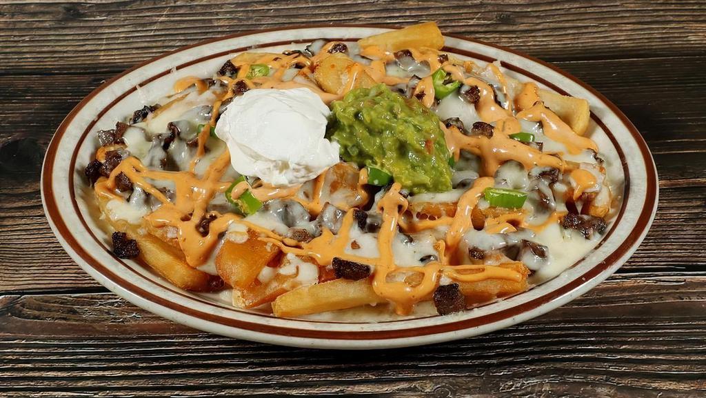 Mexi Fries · French Fries topped with Asada or Chile Verde, Monterey Jack cheese, guacamole, sour cream, serranos and chipotle cream *Choice Of Any Meat +3.00