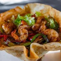 Fajita Caesar Salad · Flour tortilla bowl filled with mixed lettuce, grilled bell peppers and onions. Topped with ...