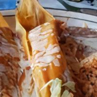 Tamales · 2 Fresh corn masa wrapped in corn husk, filled with choice of Pork, Chicken or Beef covered ...