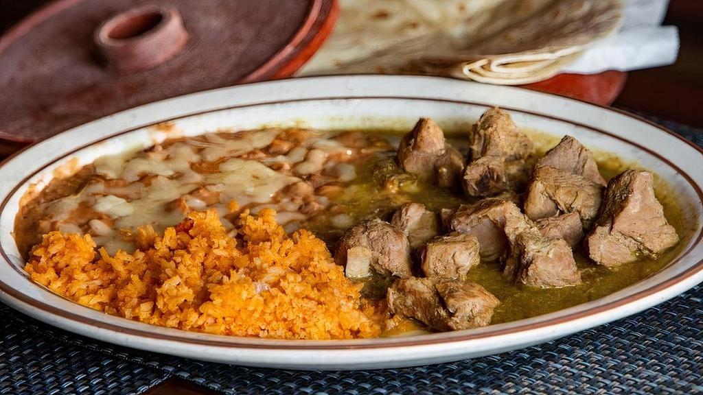Chile Verde · Tender lean pork simmered in green tomatillo sauce.  Served with rice & beans