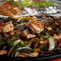 Fajitas Deluxe · Combination of Beef, Chicken, Shrimp (3).  Served with rice & beans