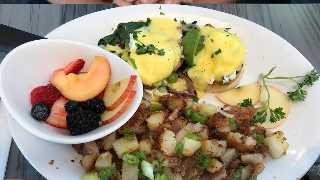 Veggie Benedict · Crispy English muffin, mushroom. Spinach, whole grilled onion, and topped with diced green onion, poached eggs and homemade hollandaise sauce .