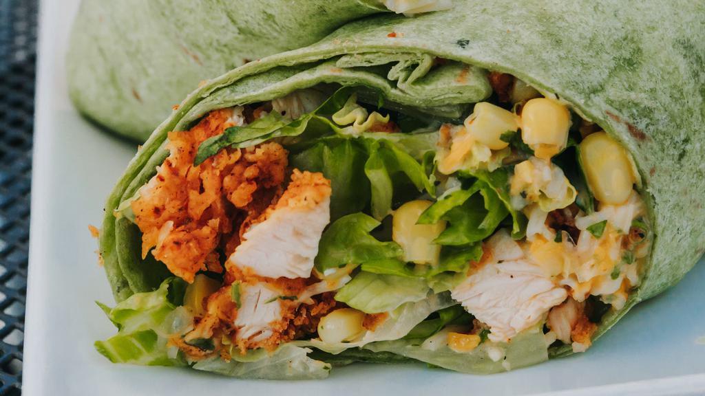 Fried Buttermilk Chicken Wrap · spinach wrap, romaine, corn, black beans, red onion, cherry tomato, tortilla strips, parmesan & cheddar cheese and spicy ranch.  Served with fries