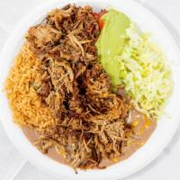 Carnitas Plate · shredded pork carnitas with pico de gallo, lettuce and guacamole on a plate with rice and be...