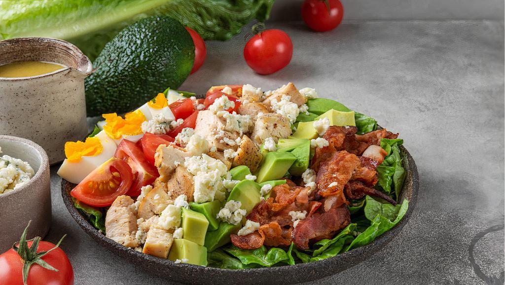 Classic Cobb Salad · Grilled chicken breast, bacon, hard boiled egg, avocado, romaine lettuce, tomato, Blue cheese and ranch.
