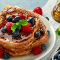 Classic French Toast · Brioche French Toast topped with fresh berries.