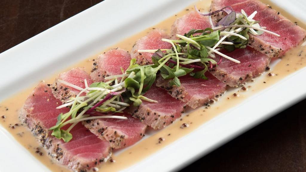 Seared Tuna* · Seared tuna with a creamy wasabi sauce, topped with organic micro greens.