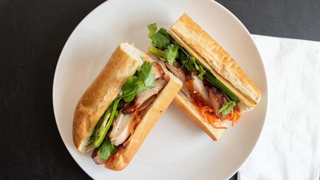 Chicken Banh Mi · Vietnamese BBQ chicken on baguette, housemade mayo, pickled carrots, jalapenos, cilantro, soy sauce.