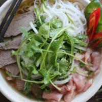 Combination Pho · 24-hour bone broth served with rare filet mignon, braised brisket, rice noodles, white & gre...