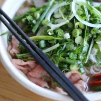Filet Mignon Pho · 24-hour bone broth served with rare filet mignon, rice noodles, white & green onions, and ci...