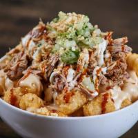 Carnitas Totchos · crispy tots, melted queso, roasted pork carnitas, cilantro tahini crema, mezlajeté hot sauce...