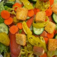 Dinner Salad · Crisp Romaine lettuce, Roma tomatoes, cucumber, carrots, pepperoncini, homemade croutons, an...