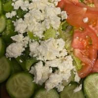 Greek Salad · Crisp Romaine lettuce, feta cheese, Roma tomato, cucumbers, Kalamata olives, red onions, gre...