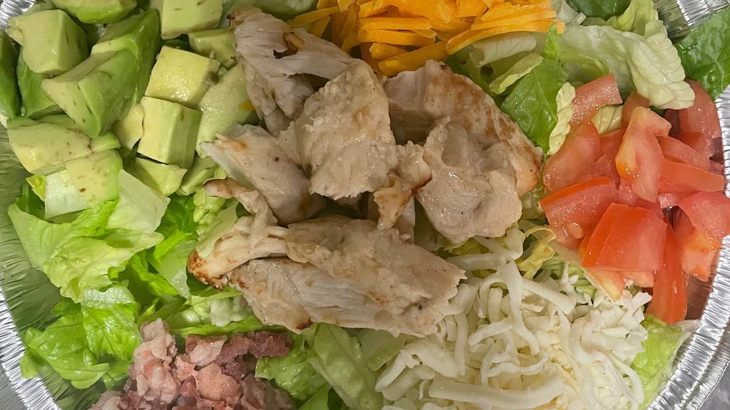Cobb Salad · Crisp Romaine lettuce, Roma tomato, crisp bacon, avocado, Monterey jack & Mild Cheddar cheese, topped with grilled chicken breast, and your choice of dressing.