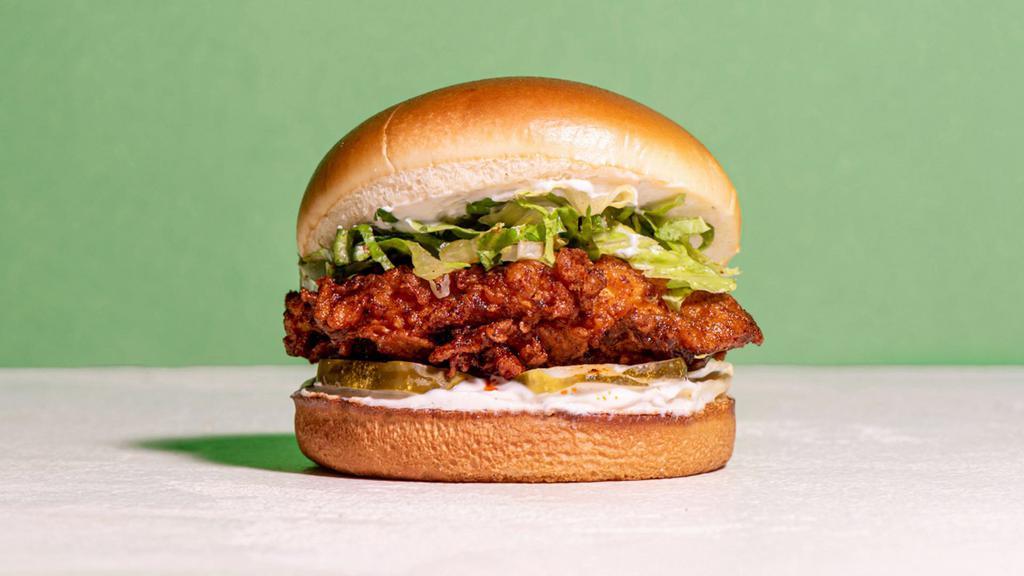 The Southern Hot Fried Chicken · Southern fried chicken breast seasoned in our signature New Orleans style spice in between a toasted brioche bun with Chili Oil Dipped Fried Chicken, pickles, mayo, shredded lettuce, brioche bun.
