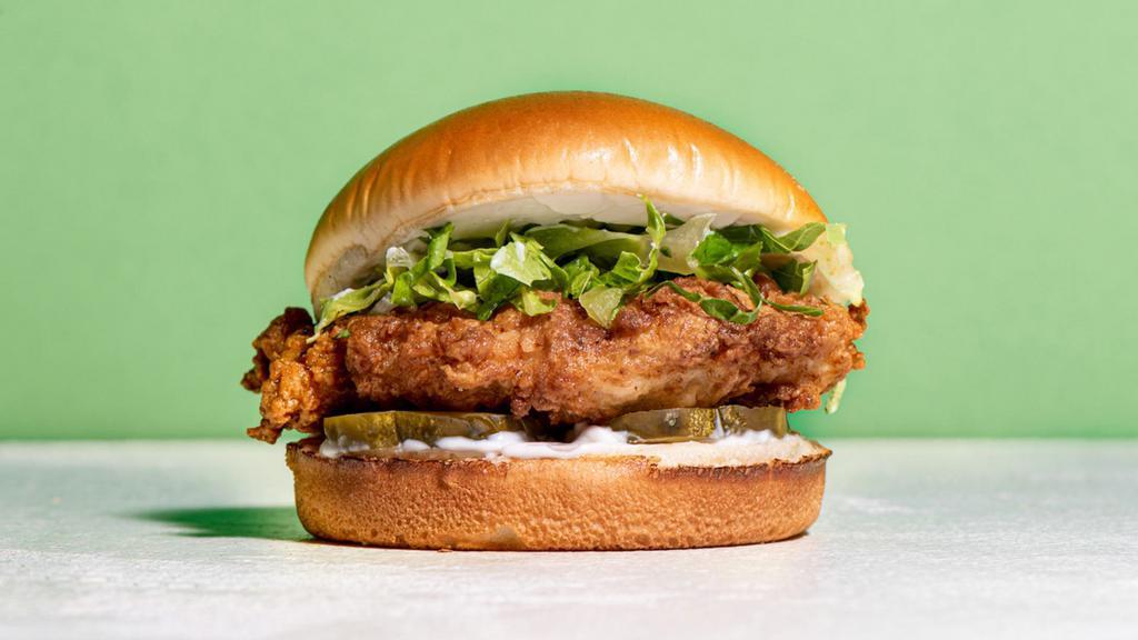 The Signature Crispy Chicken · Southern fried chicken breast seasoned in our signature New Orleans style spice in between a toasted brioche bun with pickles, mayo, sea salt, black pepper, shredded lettuce.