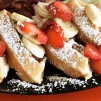 Texas French Toast · 3 slices of French toast grilled golden brown and topped with powdered sugar.