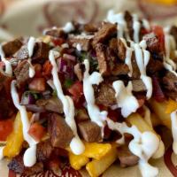 Carne Asada Fries · Fries topped with carne asada, pico de gallo, cheddar cheese, and sour cream.