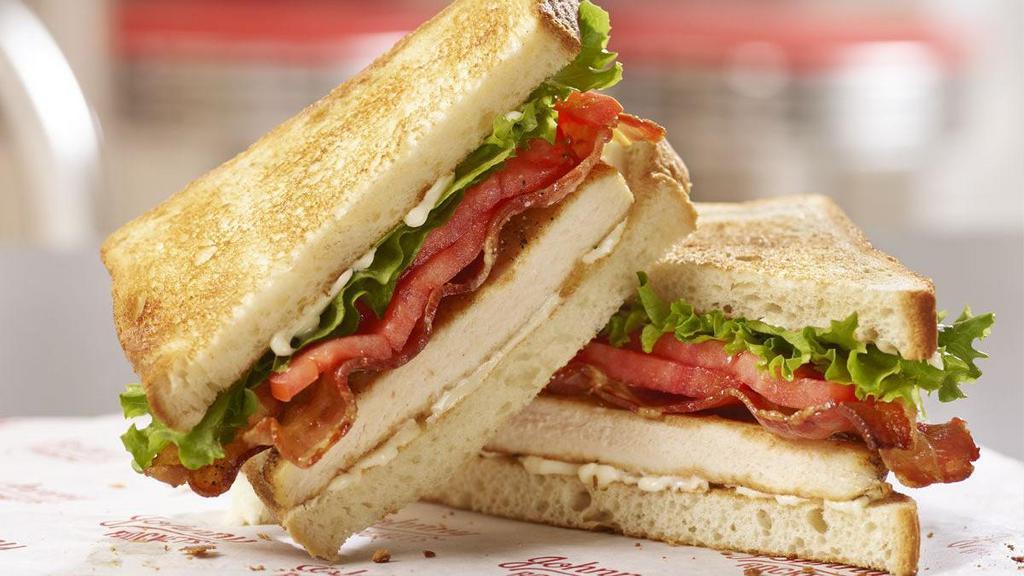 Chicken Club Sandwich · Join the club! A juicy grilled chicken breast is topped with bacon, lettuce, tomato and mayo on sourdough toast.