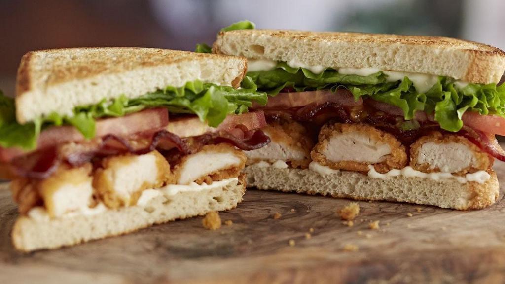 Crispy Chicken Club Sandwich · Fried for that extra crunch, this sandwich features the crispiest chicken tenders topped with bacon, lettuce, tomato and mayo on sourdough toast.