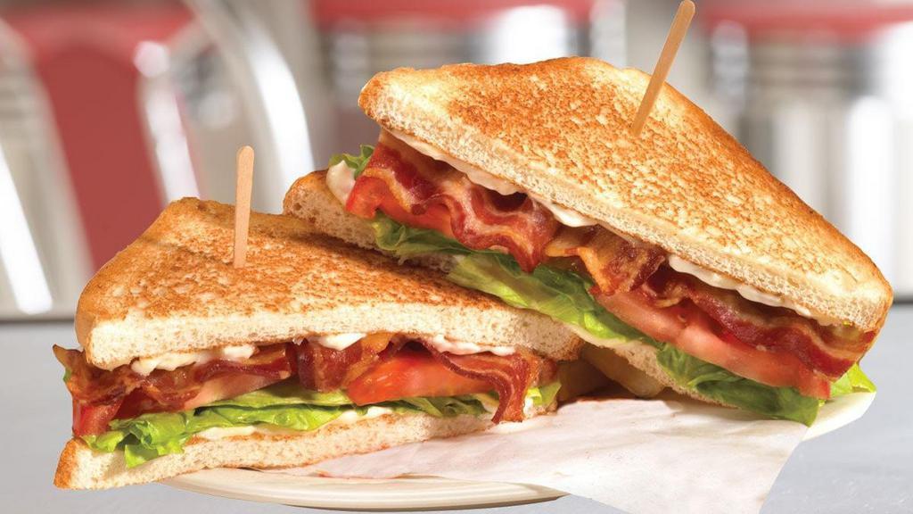Bacon, Lettuce & Tomato Sandwich · The all American classic sandwich features thick Applewood smoked bacon topped with lettuce, tomato and mayo on sourdough toast.
