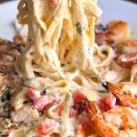Fettuccini Alfredo · Tossed in creamy alfredo sauce with fresh cherry tomatoes, basil, aged parmesan