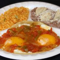 Huevos Rancheros · Two eggs sunny side up on a corn tortilla covered with ranchero sauce. Served with rice and ...