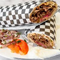 Beef Shawerma Wrap · Thin slices of marinated beef with pickles, tomatoes, summak onions and tahini sauce.