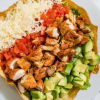 Chicken Avocado Salad · A mix of salad greens, avocado, tomatoes, grilled chicken, and cheese. Served in our edible ...