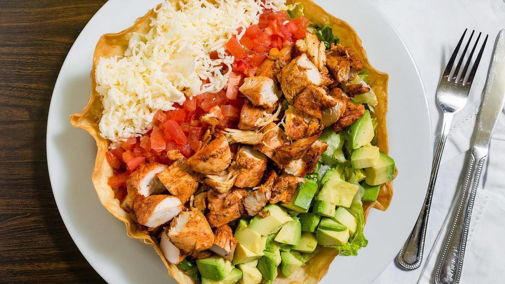 Chicken Avocado Salad · A mix of salad greens, avocado, tomatoes, grilled chicken, and cheese. Served in our edible tortilla shell.