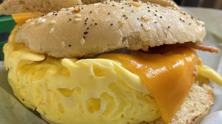 Egg On A Bagel · Two scrambled eggs topped with melted cheese.