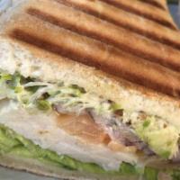 Turkey Avocado Panini · Turkey, avocado, tomato, onion, and Swiss cheese.