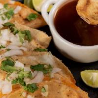 Chente Birria Mulitas · A mix between a taco and quesadilla two birria mulitas , doble tortilla and free consomme.
