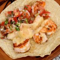 Grilled Shrimp Taco · Freshly grilled shrimp with melted cheese topped with pico de gallo and sauces.